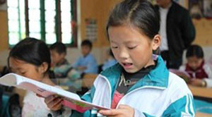 Young Vietnamese students improving reading abilities